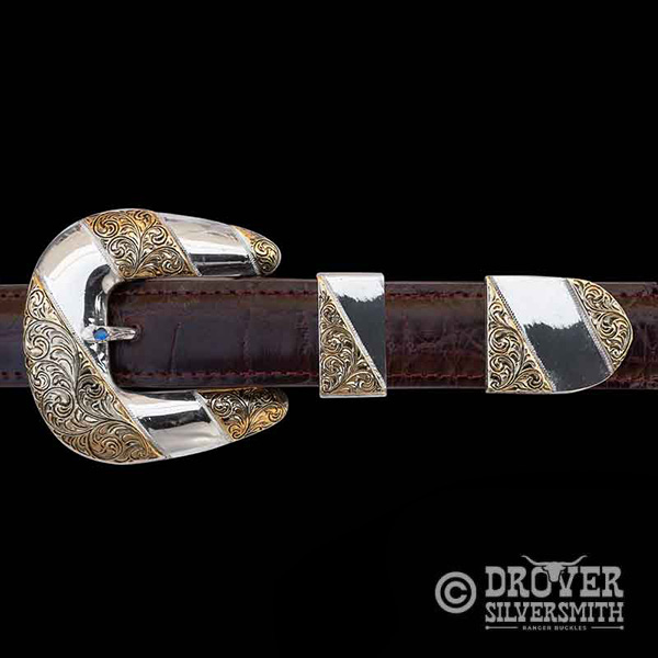 Step into luxury with The Saloon Keeper Sterling Silver Buckle Set, a half hand engraved half polished set featuring multiple jeweler's bronze strips in the buckle, tip and loop.  Add a second loop for a ranger buckle set now!